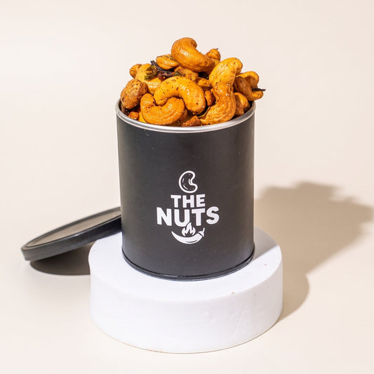 The Nuts 120g tin overflowing with spicy cashews