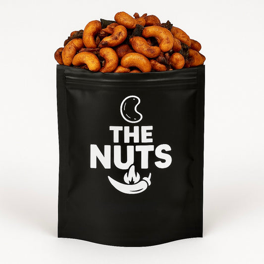 Black bag labeled 'The Nuts' filled with Spicy cashews open 